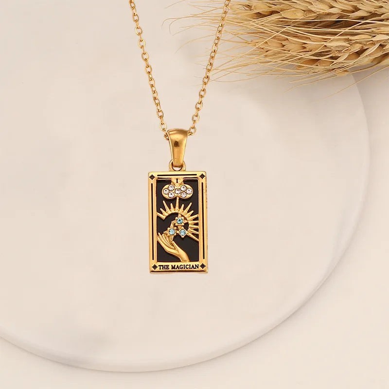 AuraTemple gold stainless steel necklace featuring a rectangular pendant with a black enamel Tarot card design, accented with cubic zirconia.