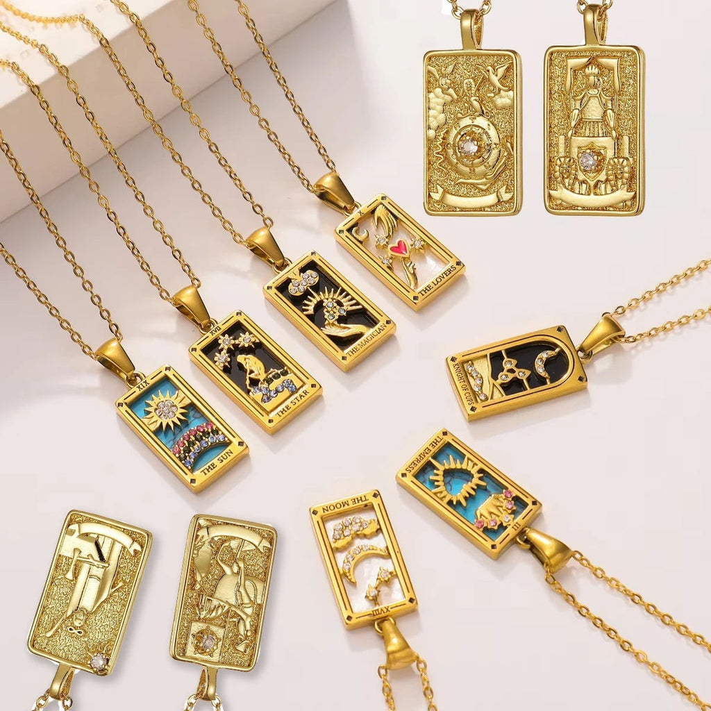 AuraTemple gold stainless steel tarot card necklaces with cubic zirconia. Designs include The Sun, The Star, The Magician, The Lovers, The Moon, and The Empress.