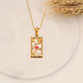 AuraTemple gold stainless steel necklace featuring a rectangular pendant with a Tarot card design, including a red heart, moon, and stars.