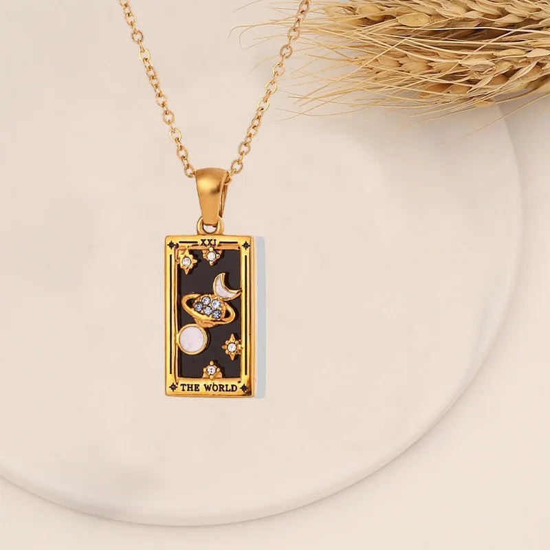 AuraTemple gold stainless steel necklace with a rectangular pendant featuring a black tarot card design with celestial motifs and cubic zirconia.