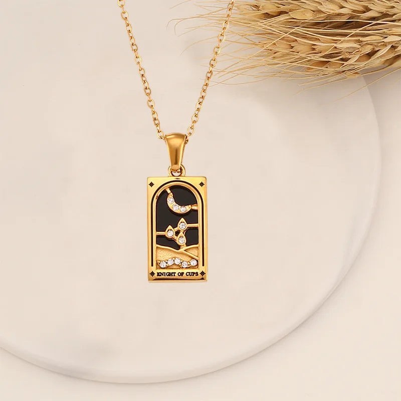 AuraTemple gold stainless steel necklace with a rectangular pendant featuring a black tarot card design with a crescent moon, stars, and cubic zirconia accents.