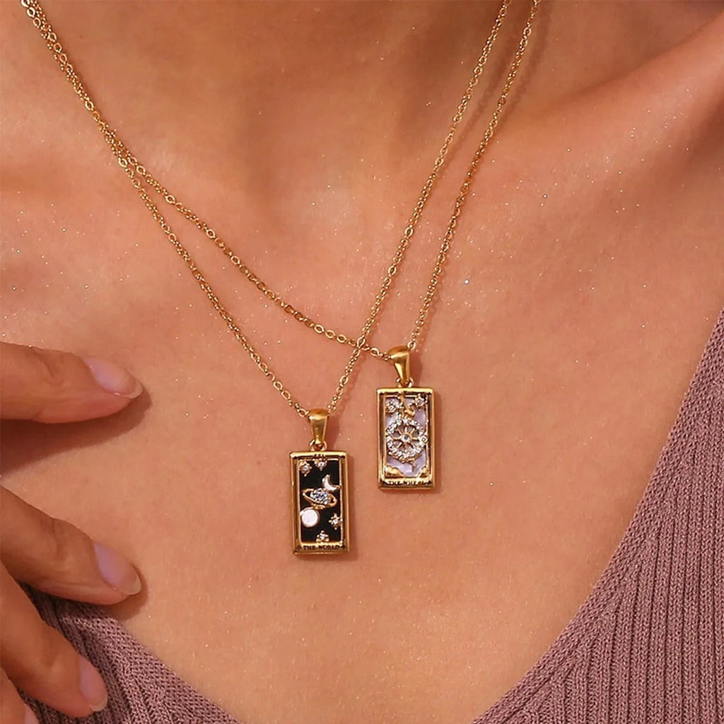 AuraTemple gold stainless steel necklace with rectangular tarot card pendants featuring celestial and wheel designs with cubic zirconia.