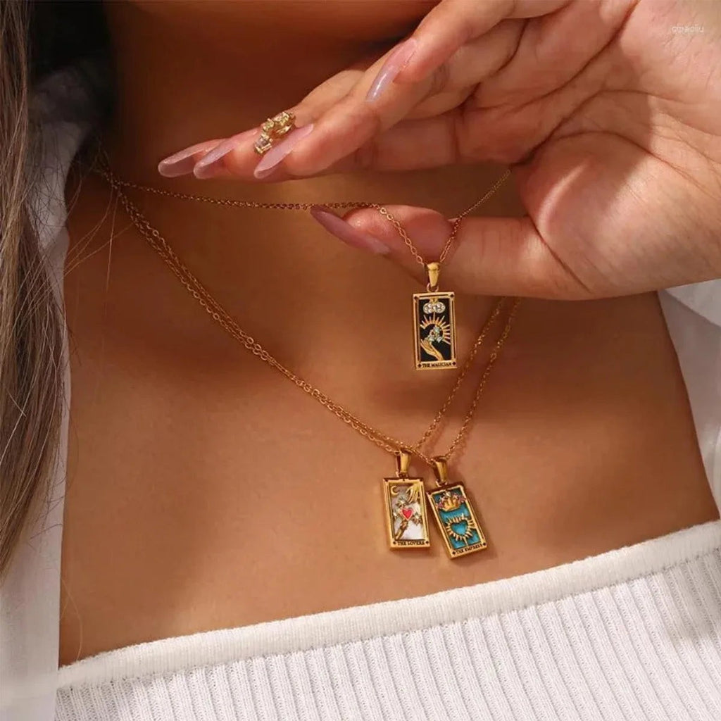 AuraTemple gold stainless steel necklace with rectangular tarot card pendants featuring The Magician, The Lovers, and The Empress designs.